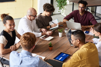 A group of professionals engaged in a meeting, discussing company benefits to employees.