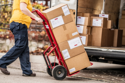 Postal worker moving packages, highlighting postal short-term disability.