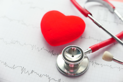 Stethoscope and red heart on an ECG graph symbolizing USPS health benefits.