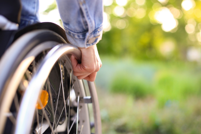 Close-up of a person in a wheelchair outdoors, representing support through disability insurance.